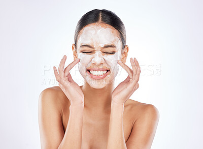 Buy stock photo Shot of a young woman posing against a studio background while wearing a face mask