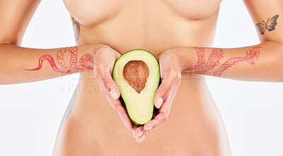 Buy stock photo Studio shot of an unrecognizable woman holding an avocado against a white background