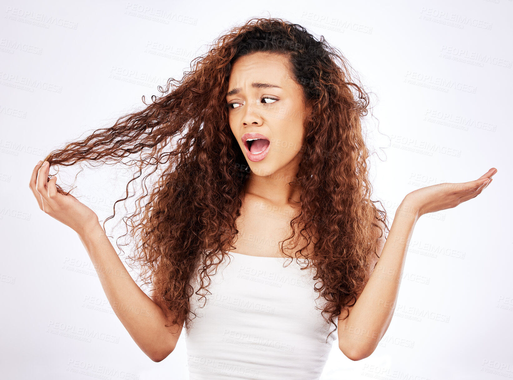 Buy stock photo African woman, confused and curly hair in studio with what, why or shocked gesture for damage or frizz. Young person or model with worry for growth, hairstyle and care tips on a white background