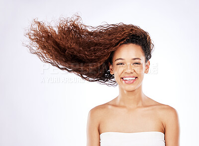 Buy stock photo Portrait, studio and woman for haircare and beauty, shampoo and treatment on white background. Smile, face and conditioner for curly hair hydration, grooming and hairstyle with wind for female person