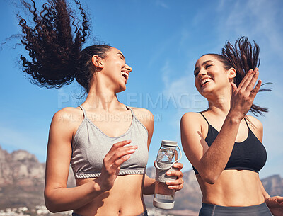 Buy stock photo Shot of two beautiful young woman running together