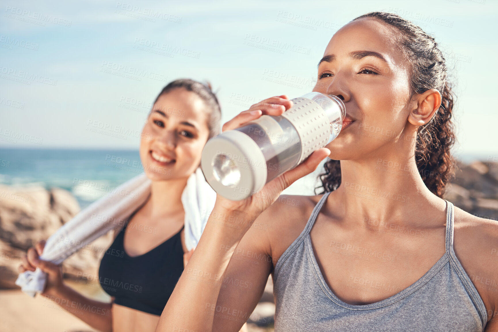 Buy stock photo Shot of two friends taking a break during a workout