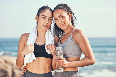 Buy stock photo Shot of two friends taking a break during a workout