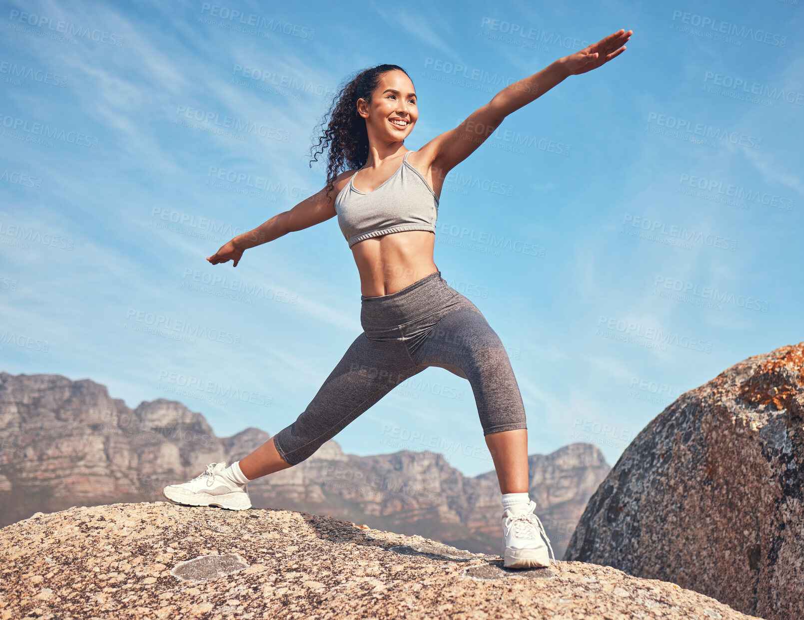 Buy stock photo Outdoor, yoga and woman with smile on rock, balance practice and holistic heath routine for fitness. Low angle, posture and person with warrior pose for wellness, exercise and stretching in nature
