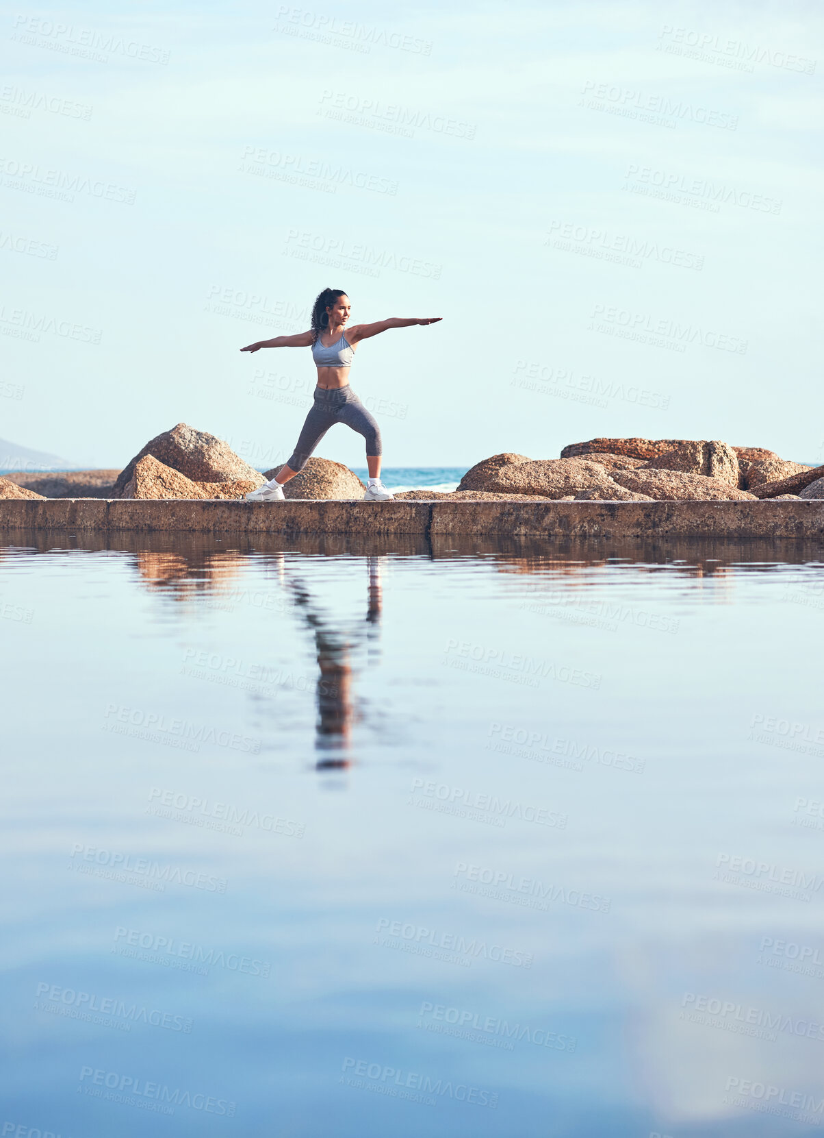 Buy stock photo Shot of a young woman practicing yoga during a workout