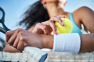 Buy stock photo Cropped shot of an unrecognisable woman standing alone and leaning on the tennis net during practice