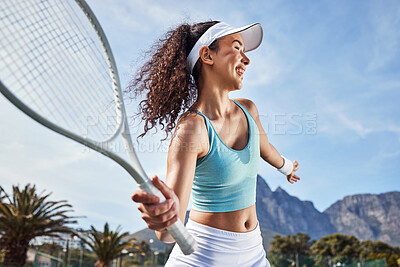 Buy stock photo Shot of an attractive young woman standing alone and getting ready to hit the ball during a game of tennis