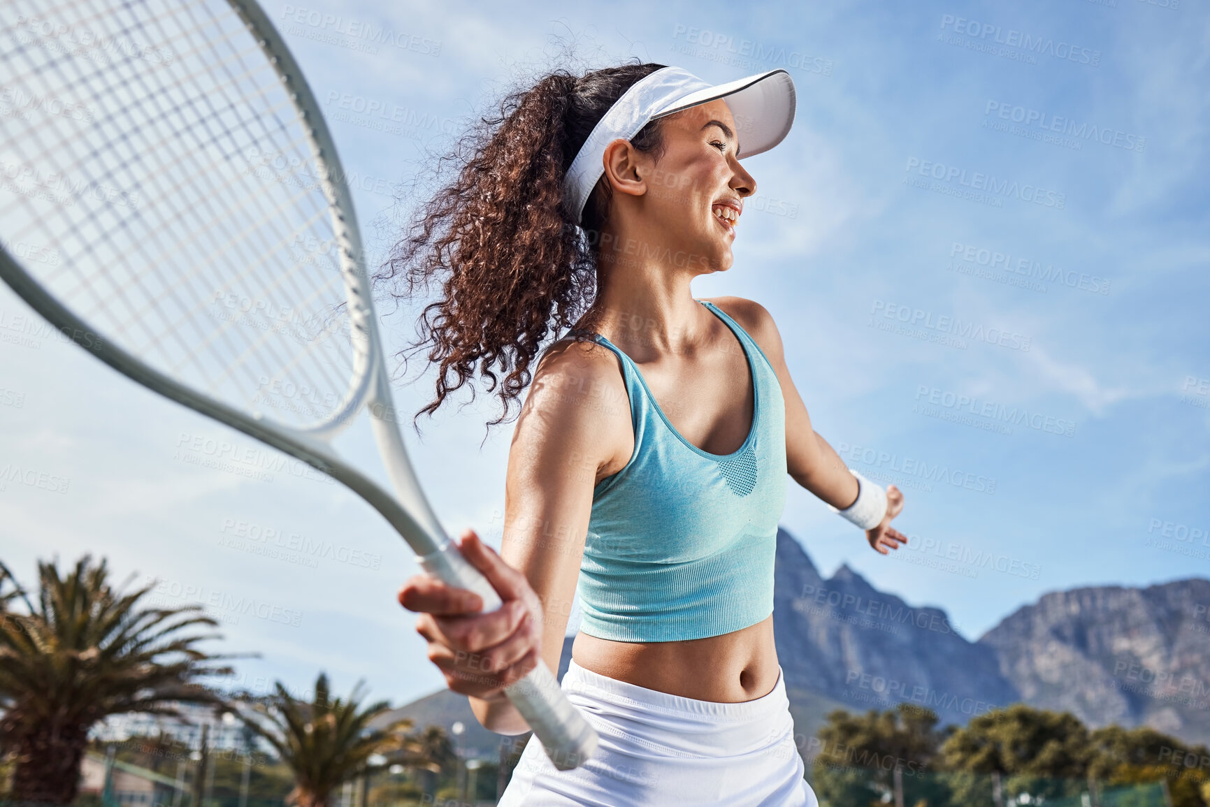 Buy stock photo Shot of an attractive young woman standing alone and getting ready to hit the ball during a game of tennis