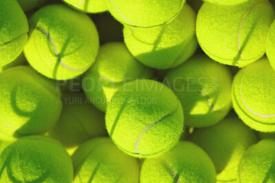 Buy stock photo Shot of an empty tennis court and tennis balls during the day