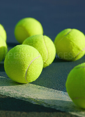 Buy stock photo Shot of an empty tennis court and tennis balls during the day