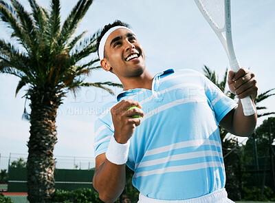 Buy stock photo Shot of a handsome young man getting ready to serve a ball during a tennis match