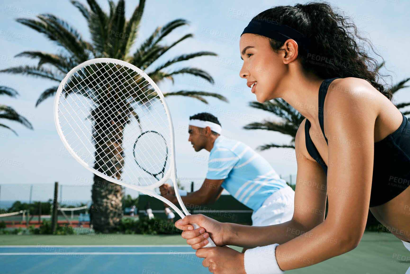 Buy stock photo Shot of an attractive young woman standing and playing tennis with her teammate