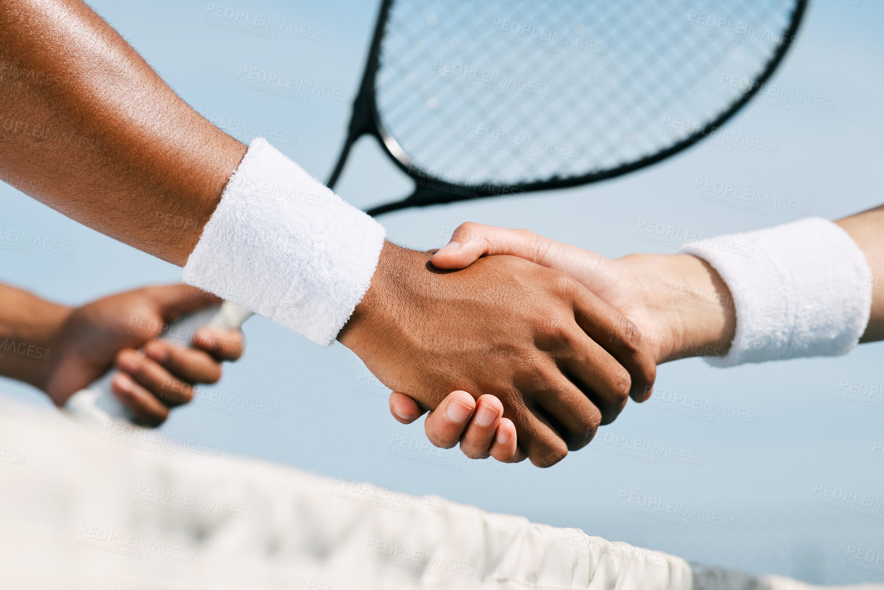 Buy stock photo Shot of two unrecognizable tennis players shaking hands during a tennis match