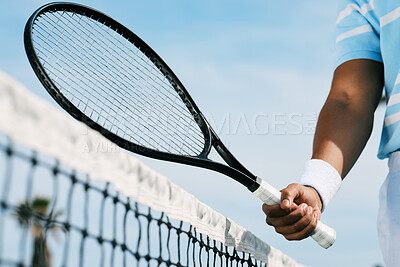 Buy stock photo Cropped shot of an unrecognizable man holding a racket during a tennis match