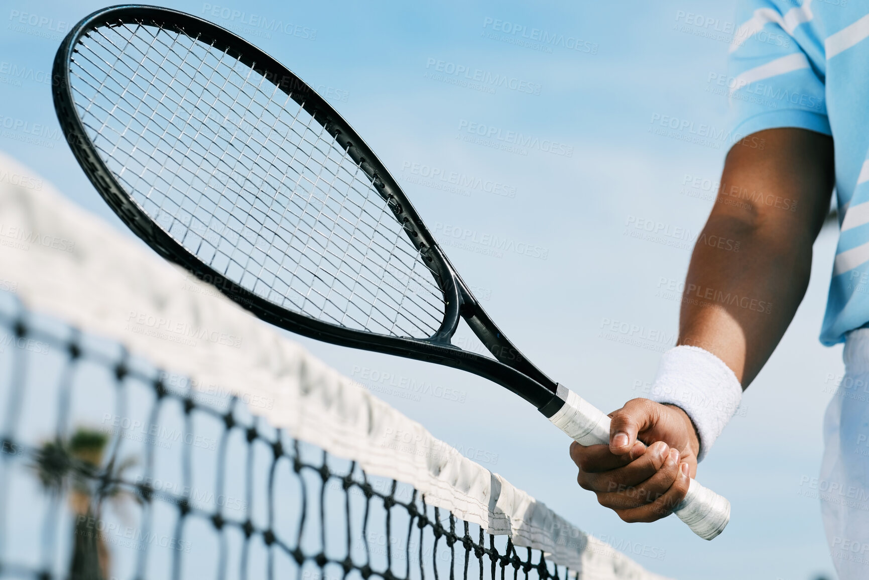 Buy stock photo Cropped shot of an unrecognizable man holding a racket during a tennis match