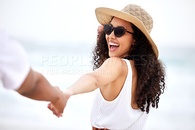 Buy stock photo Shot of a young couple spending a day at the beach