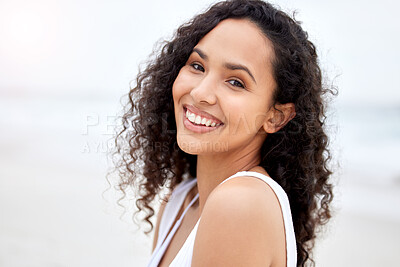 Buy stock photo Shot of a young woman enjoying a day at the beach