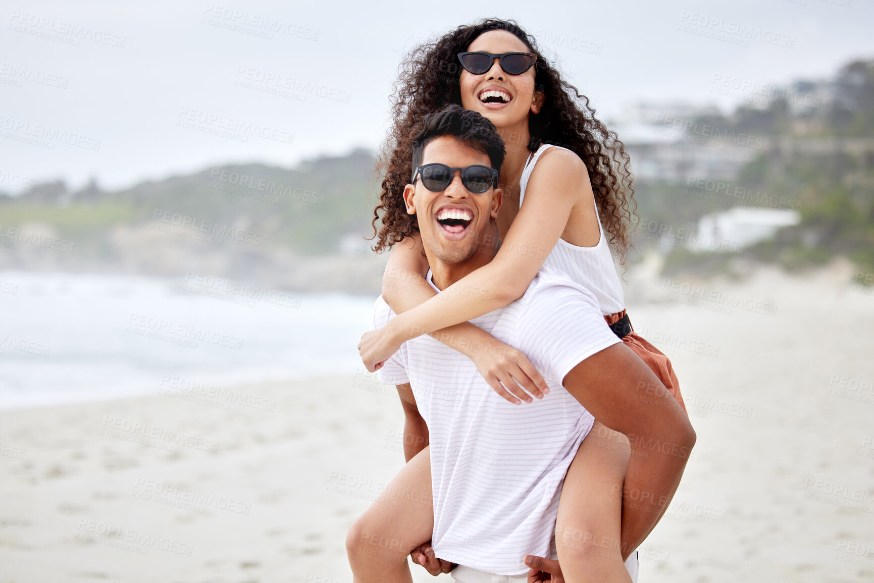 Buy stock photo Happy couple, beach and piggyback for holiday, vacation and bonding with romance, fun and adventure. Excited portrait of young man and woman in sunglasses in Mauritius for tourism, travel and love