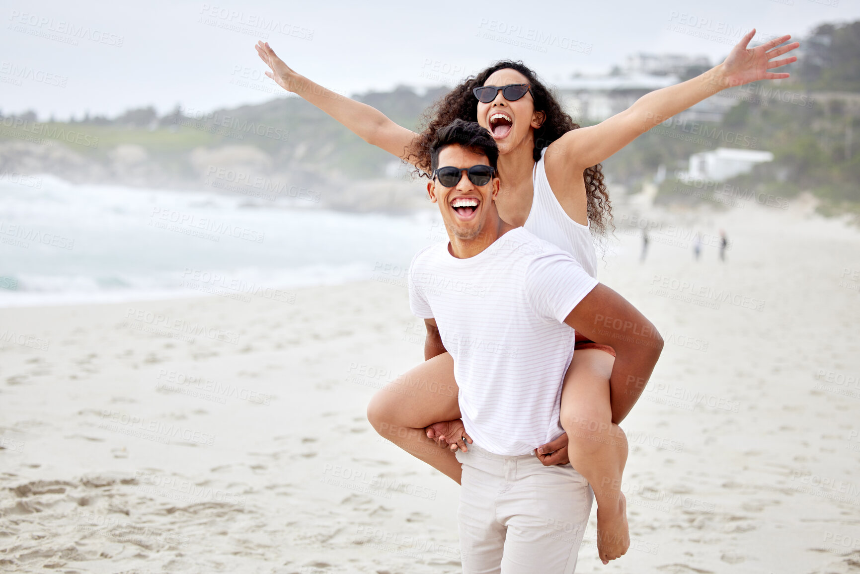 Buy stock photo Excited couple, beach and piggyback for holiday, vacation and celebration of travel success, fun and adventure. Happy young man and woman in sunglasses with wow, yes and arms up in San Francisco, USA