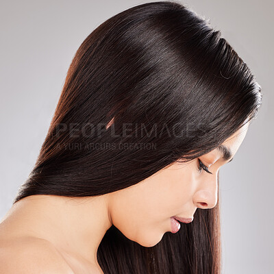 Buy stock photo Studio shot of a woman with beautiful brown hair posing against a grey background