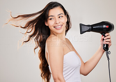 Buy stock photo Blow dry, woman and hair care with natural beauty, hairstyle and salon treatment in studio. Gray background, young female model and person with a smile from curly haircare shine with hairdryer