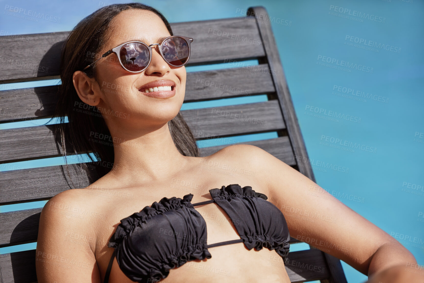Buy stock photo Woman, smile and pool with tanning, resting and water for summer vacation or holiday alone. Luxury, deck chair and wellness for female tourist enjoying travel or relaxation outdoor with sunglasses