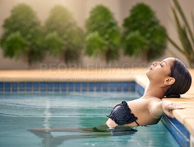Buy stock photo Cropped shot of an attractive young woman relaxing in a swimming pool