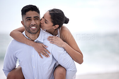 Buy stock photo Love, piggyback and couple at beach for travel, summer vacation or adventure. Smile, ocean and happy woman kiss man on afternoon date for honeymoon, anniversary or weekend trip in California