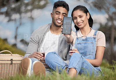 Buy stock photo Couple, smartphone and selfie at picnic in park for anniversary, romance and love in Peru. Happy man, woman and together with phone in field for picture, wine and celebration in relationship