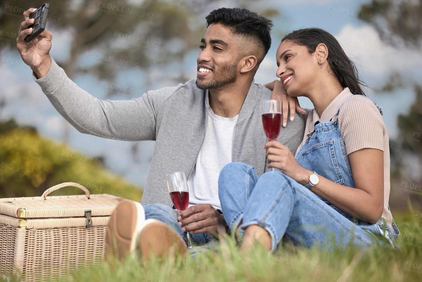 Buy stock photo Happy, couple or picnic selfie outdoor in park for romantic date, love or celebration together with drinks. People, man and woman smile in nature for bonding, relationship and calm day with wine