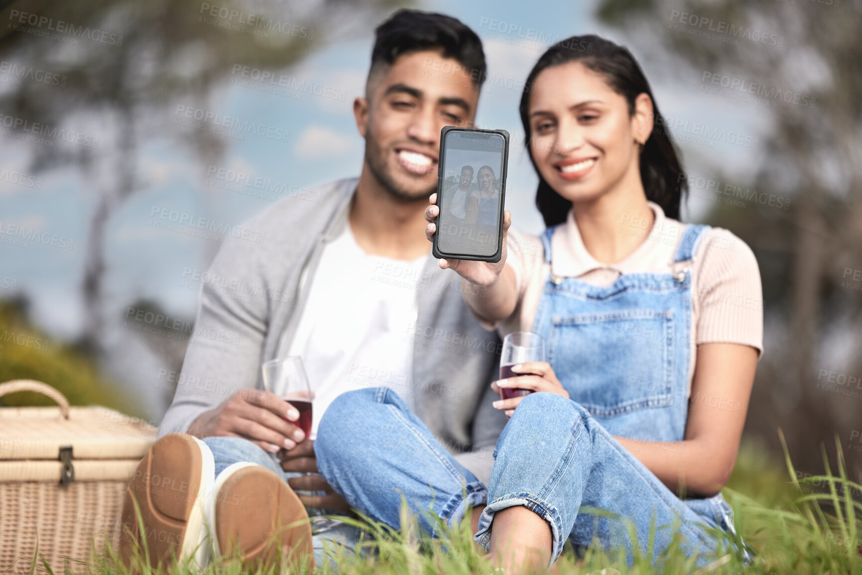 Buy stock photo Happy, couple or picnic selfie outdoor in park for romantic date, love or celebration together with drinks. People, man and woman smile in nature for bonding, relationship and calm day with wine