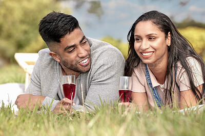 Buy stock photo Couple, happy and love in nature with wine glass for date, picnic and relax in field. Man, woman and romantic in park for celebration, anniversary and vacation or travel to countryside together