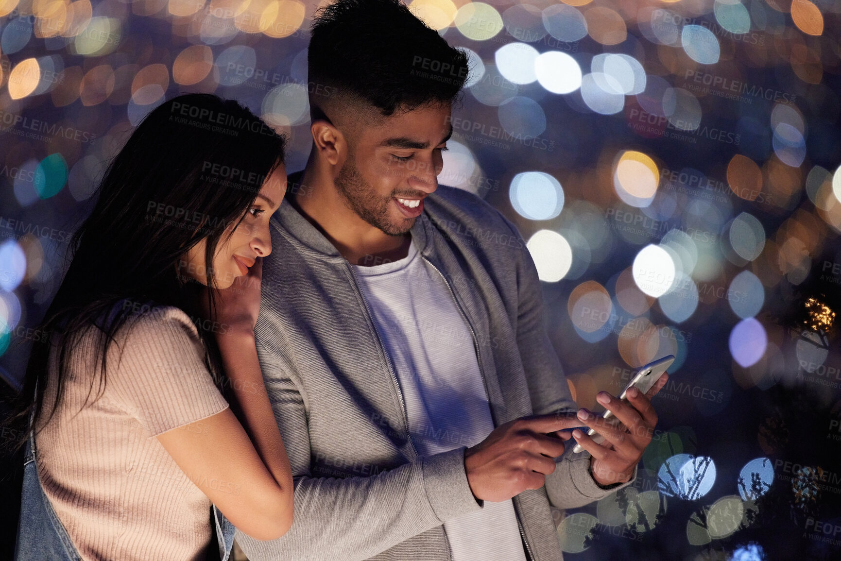 Buy stock photo Love, phone and smile with couple on bokeh background together for bonding, date or romance. App, contact or social media with man and woman on mobile for communication, networking or text message