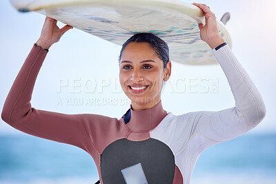 Buy stock photo Girl, surfing and board on head at beach, workout and training for water sports competition. Female person, health and travel to ocean or sea for wave, fitness and athlete for exercise in nature