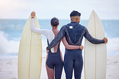 Buy stock photo Couple, surfer and hug at ocean together for wellness, love and fitness in nature. Man, woman and swim for exercise or training at beach for holiday, vacation and outdoor workout or water sport