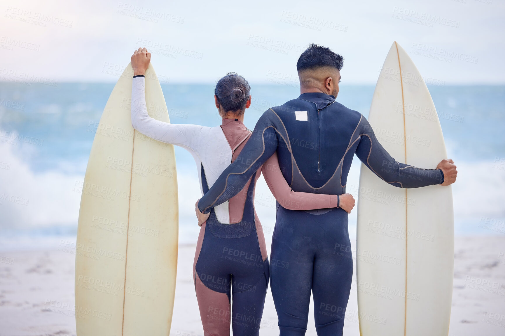 Buy stock photo Couple, surfer and hug at ocean together for wellness, love and fitness in nature. Man, woman and swim for exercise or training at beach for holiday, vacation and outdoor workout or water sport