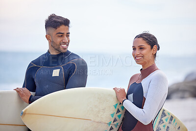 Buy stock photo Surf board, couple and happy together on beach for relationship, activity and exercise by ocean. Smiling man, woman and fitness in nature for tides, waves and support with swimwear on seashore