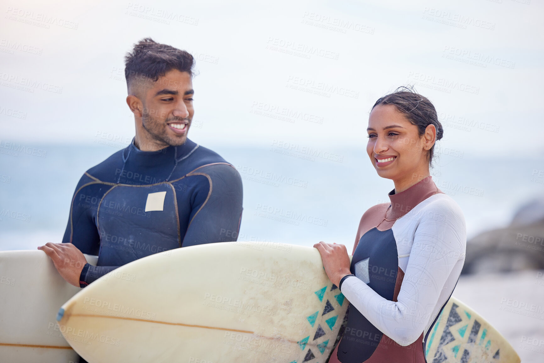 Buy stock photo Surf board, couple and happy together on beach for relationship, activity and exercise by ocean. Smiling man, woman and fitness in nature for tides, waves and support with swimwear on seashore