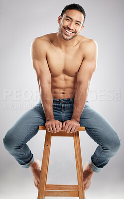 Buy stock photo Man, stool and topless with muscle in studio portrait with smile, jeans and pride for healthy body. Person, model or bodybuilder with results, wellness and lose weight for change by white background