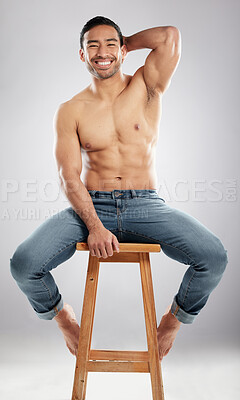 Buy stock photo Man, stool and shirtless with muscle in studio portrait with smile, jeans or pride for healthy body. Person, model or bodybuilder with results, wellness and lose weight for change by white background