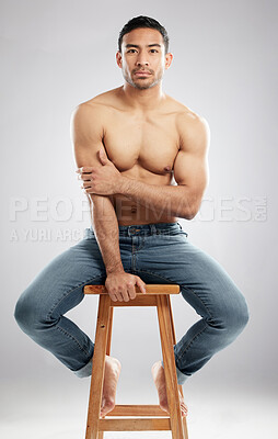 Buy stock photo Man, chair and shirtless in jeans for studio portrait with muscle, strong or pride for healthy body. Person, model or bodybuilder with results, wellness and lose weight for change by white background