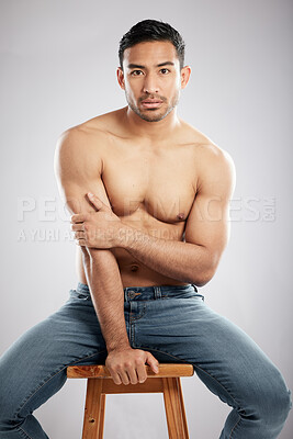 Buy stock photo Man, chair and topless with jeans in studio portrait with muscle, strong and pride for healthy body. Person, model or bodybuilder with results, wellness and lose weight for change by white background