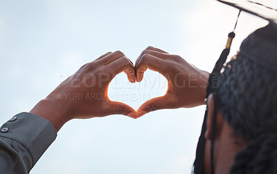 Buy stock photo Black girl, sign and heart hands in outdoor on graduation for love for education, achievement and celebration for degree. Student, gesture and gratitude for accomplishment, graduate and blue sky.