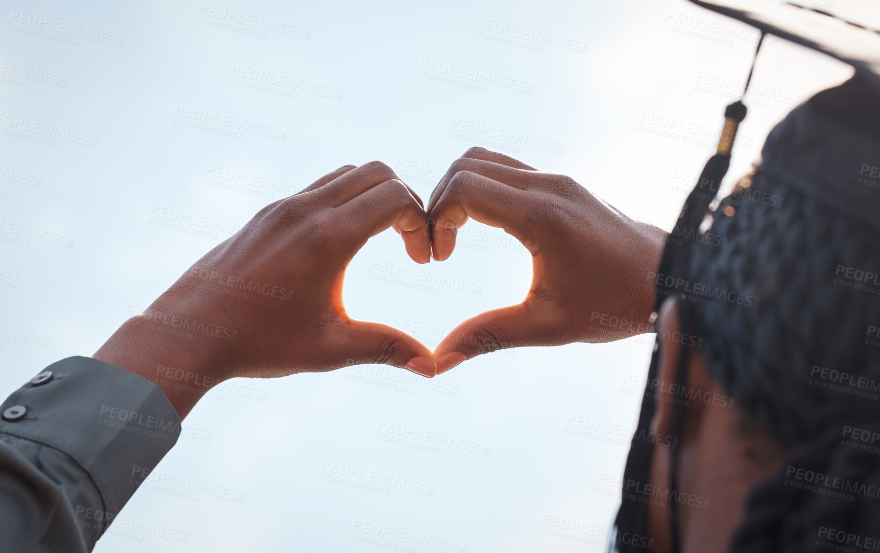 Buy stock photo Black girl, sign and heart hands in outdoor on graduation for love for education, achievement and celebration for degree. Student, gesture and gratitude for accomplishment, graduate and blue sky.