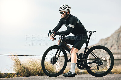 Buy stock photo Full length shot of a handsome mature man taking a break while cycling outdoors