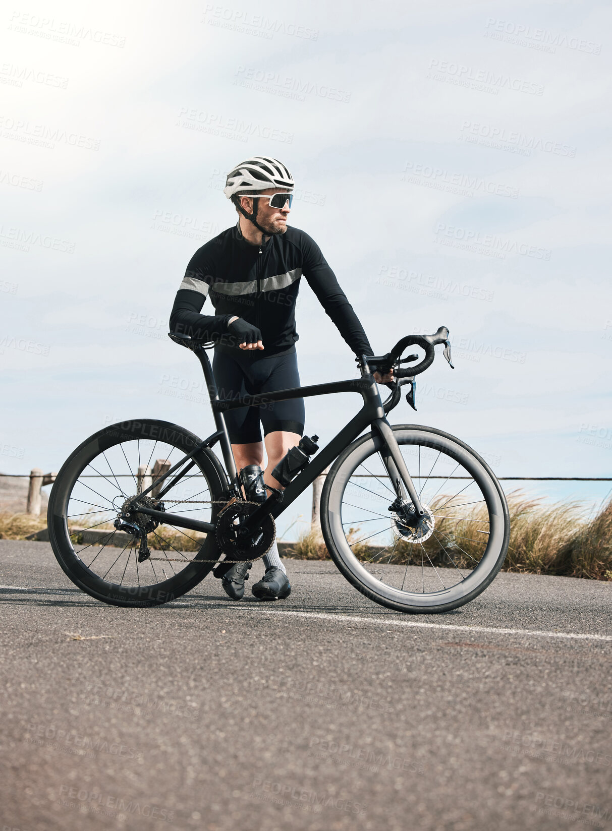 Buy stock photo Full length shot of a handsome mature man taking a break while cycling outdoors