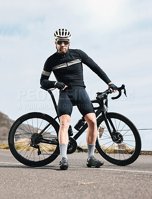 Buy stock photo Full length shot of a handsome mature man taking a break while cycling outdoors