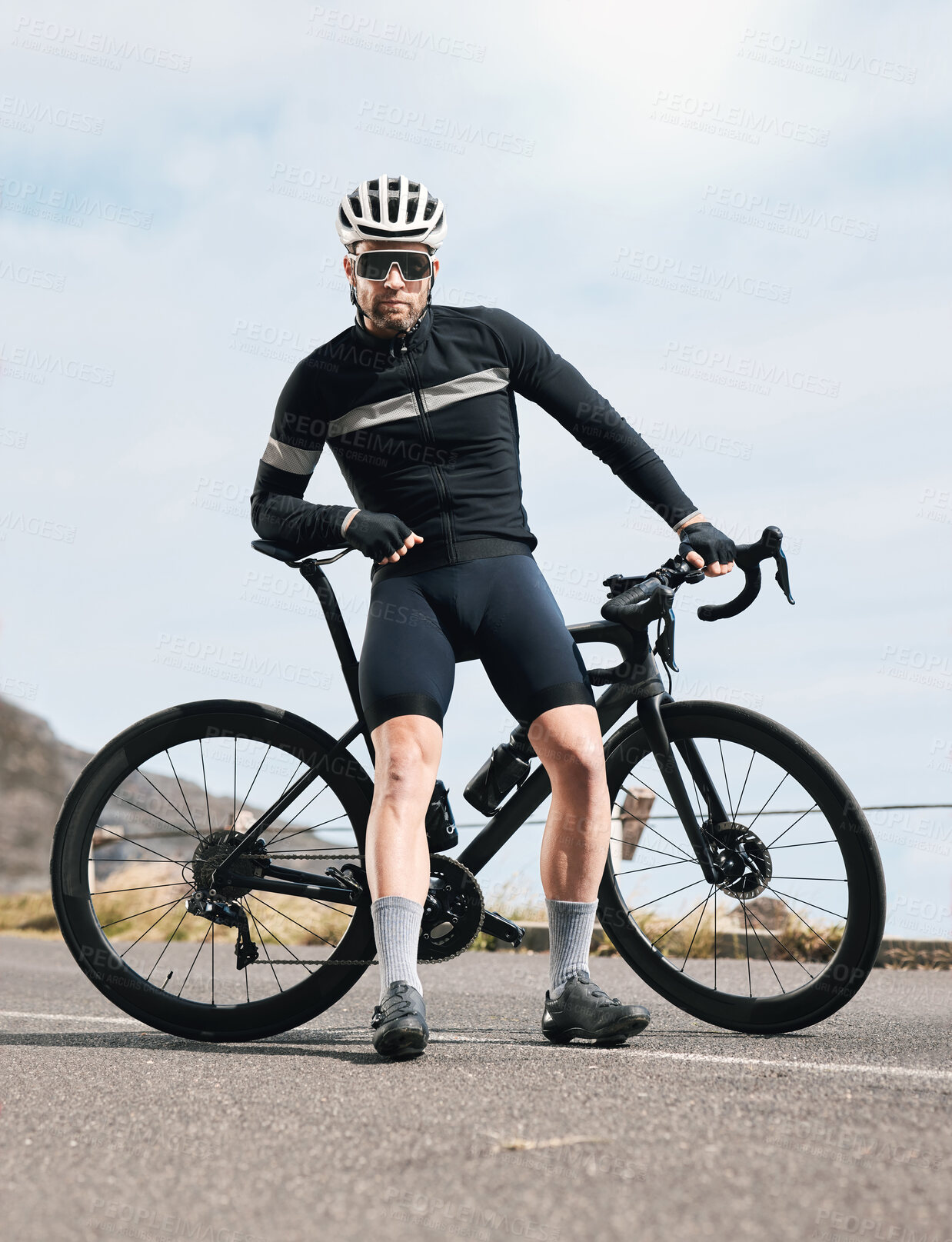 Buy stock photo Full length shot of a handsome mature man taking a break while cycling outdoors