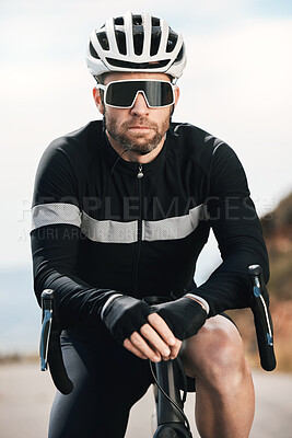 Buy stock photo Cropped shot of a handsome mature man taking a break while cycling outdoors