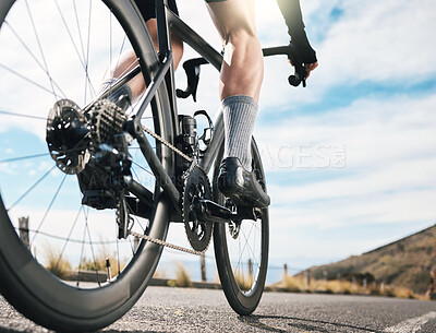 Buy stock photo Rearview shot of an unrecognizable man cycling outdoors